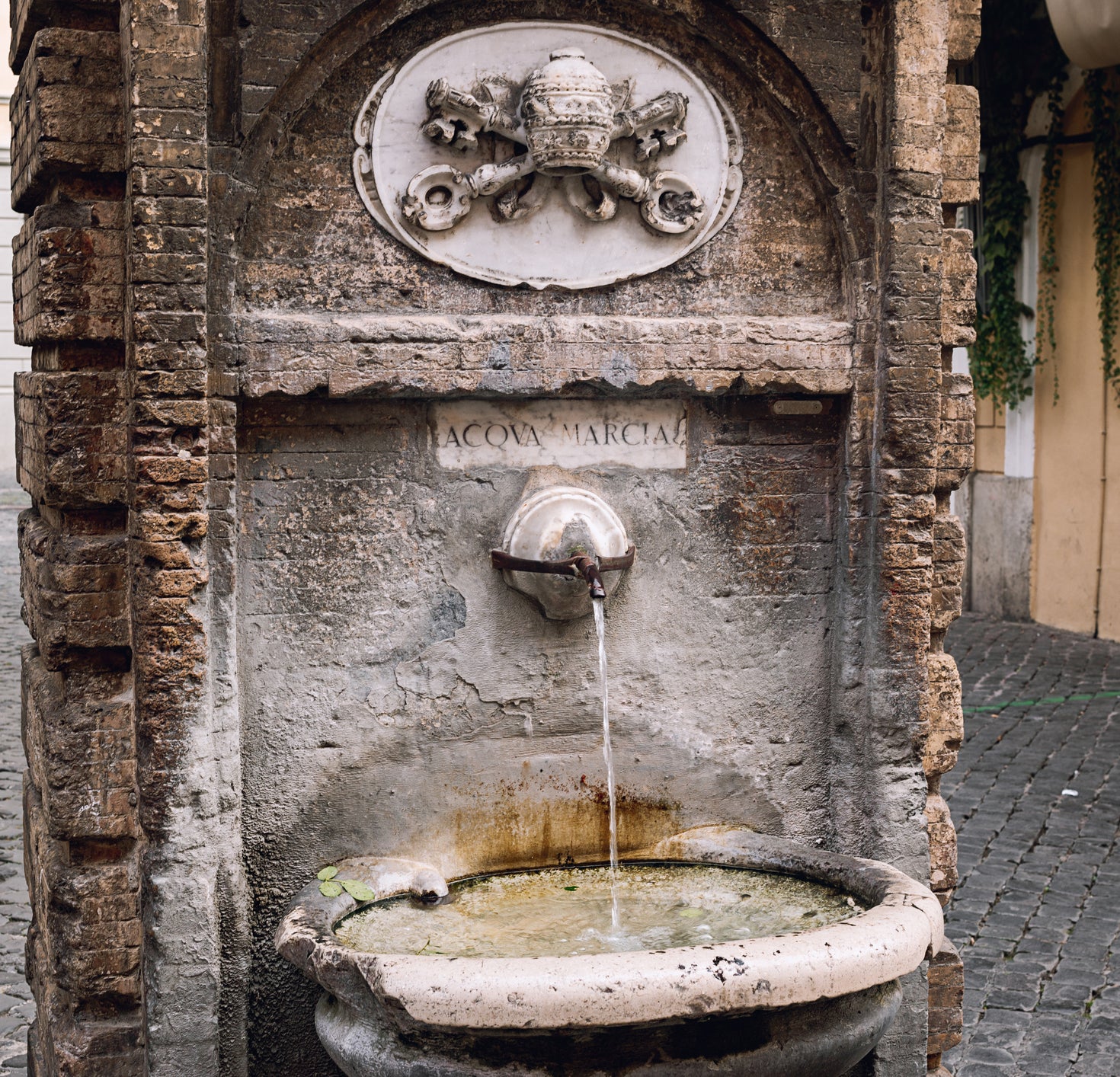 Old traditional drinking fountain with cold water in Rome