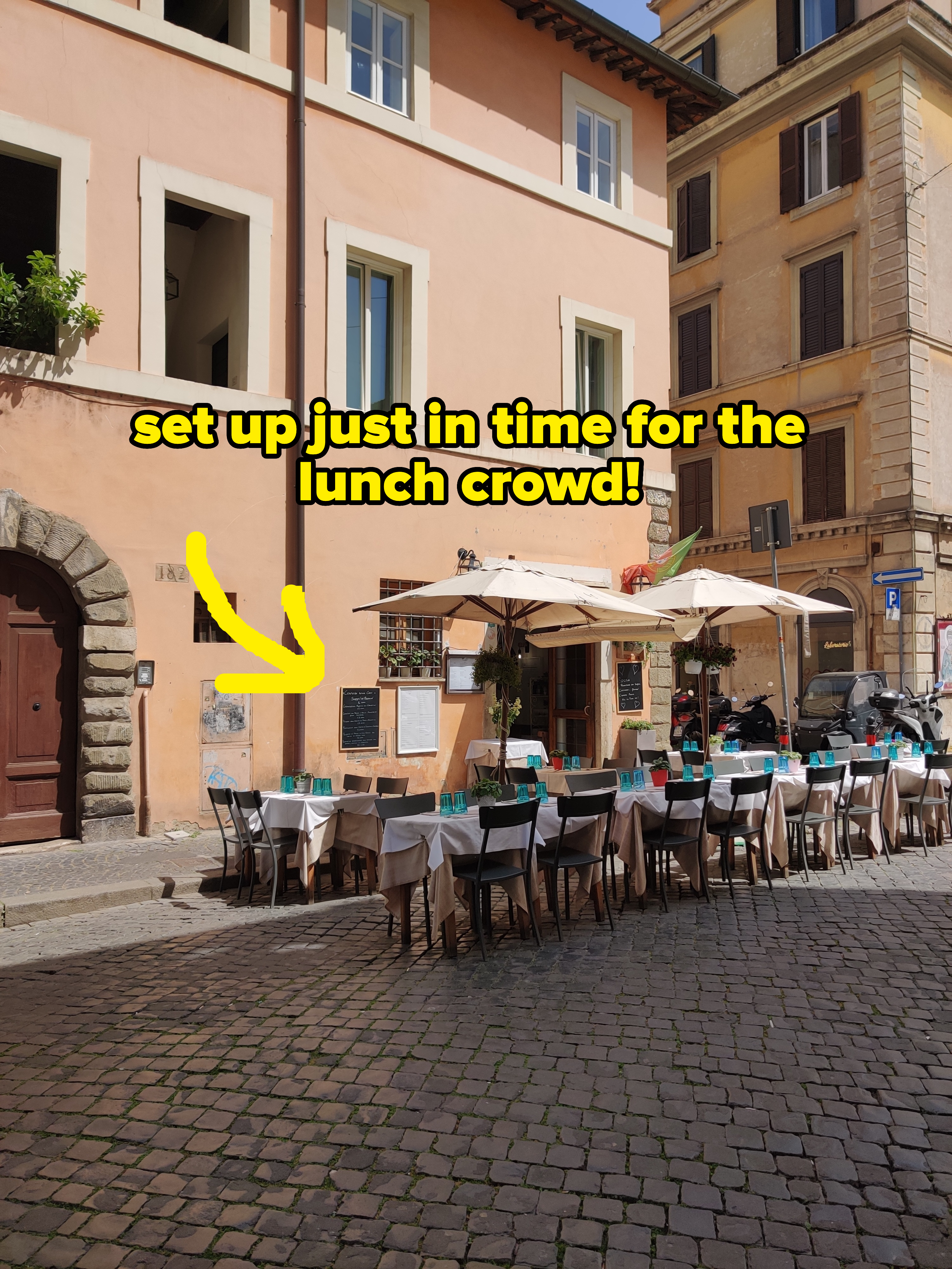 Sidewalk café with outdoor seating in a quaint European street setting, inviting for travelers