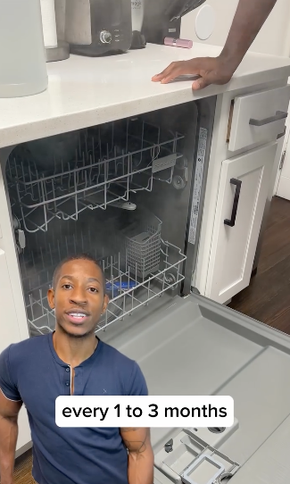 A person stands by an open dishwasher, with text &quot;every 1 to 3 months&quot; indicating maintenance frequency