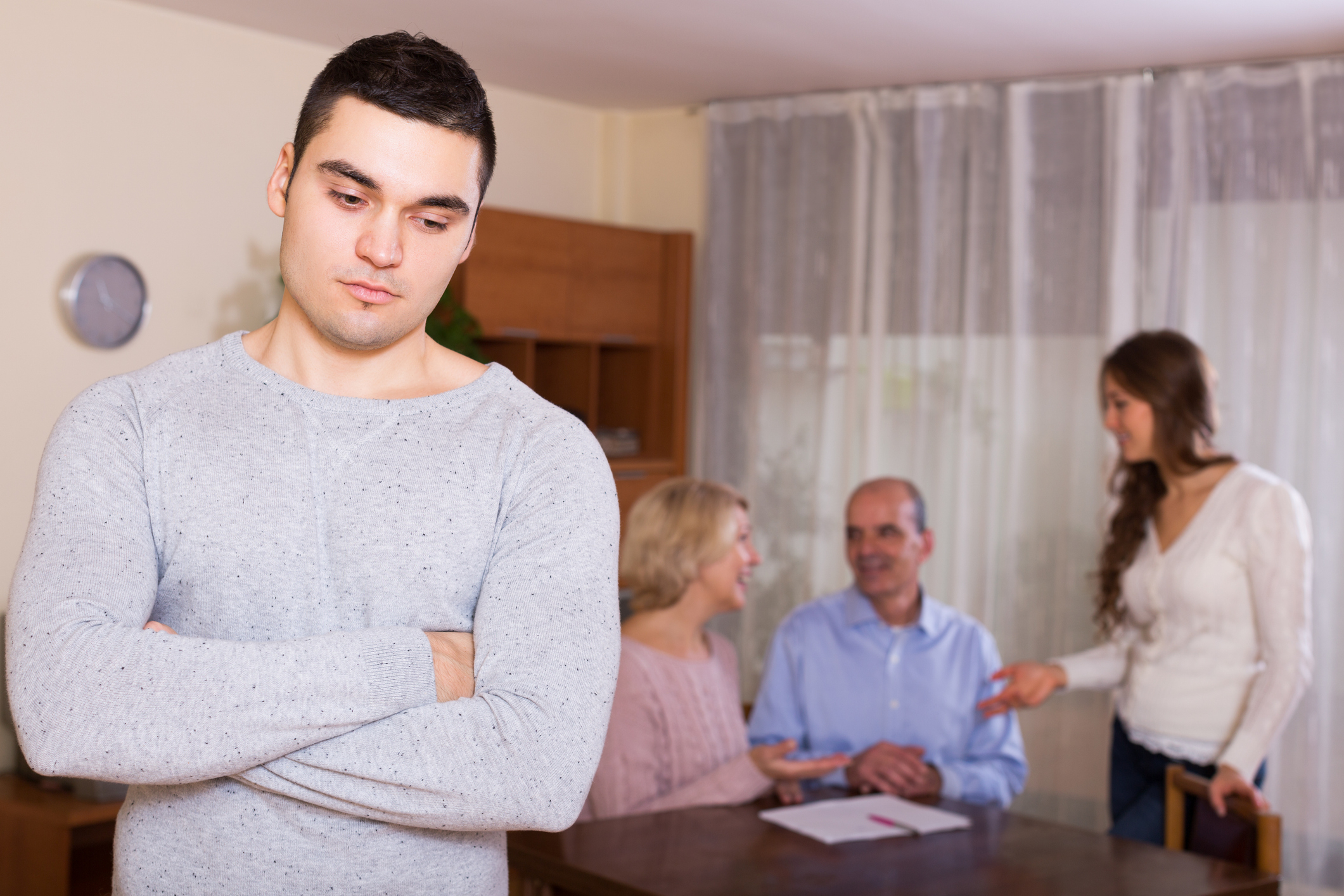 Unhappy man faced with misunderstanding big family