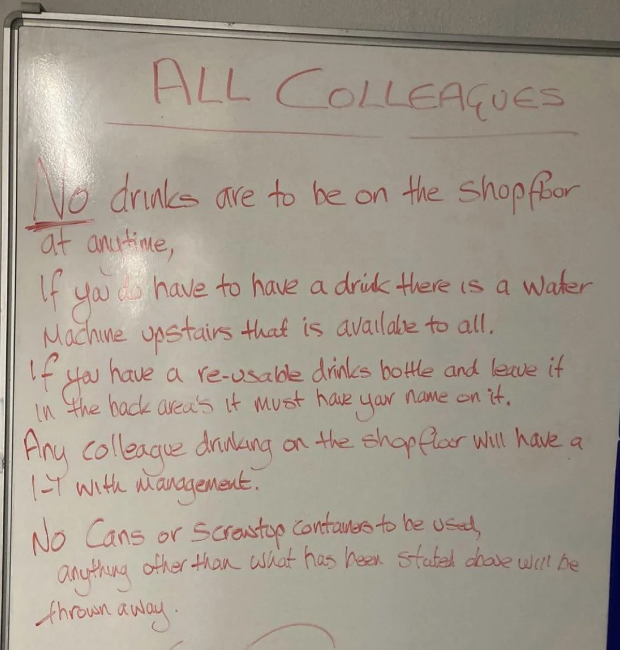 Whiteboard with rules for colleagues about no drinks on the shop floor, availability of water machine, re-usable drink bottles, and policy on cans