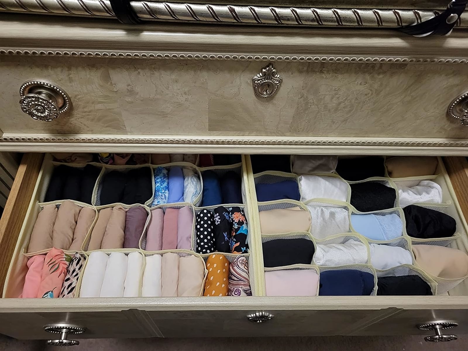 An open drawer organized with various folded socks in different styles and patterns for easy selection