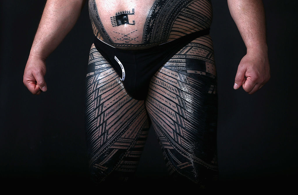 Close-up of a person&#x27;s midsection with patterned leggings and a black waist pouch