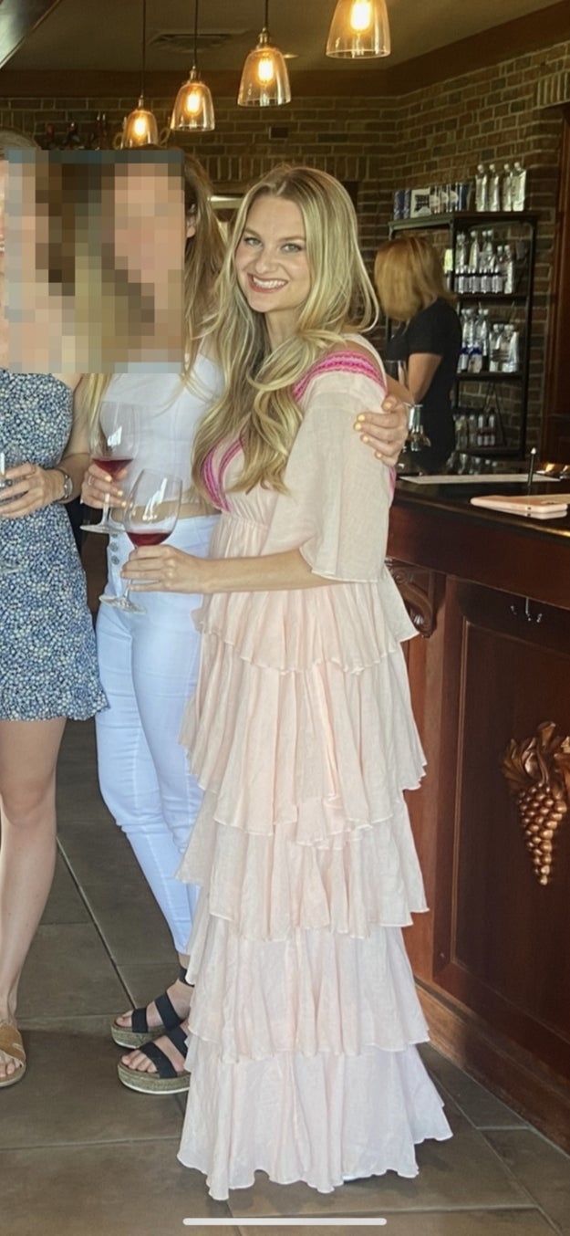 The author in a pink dress