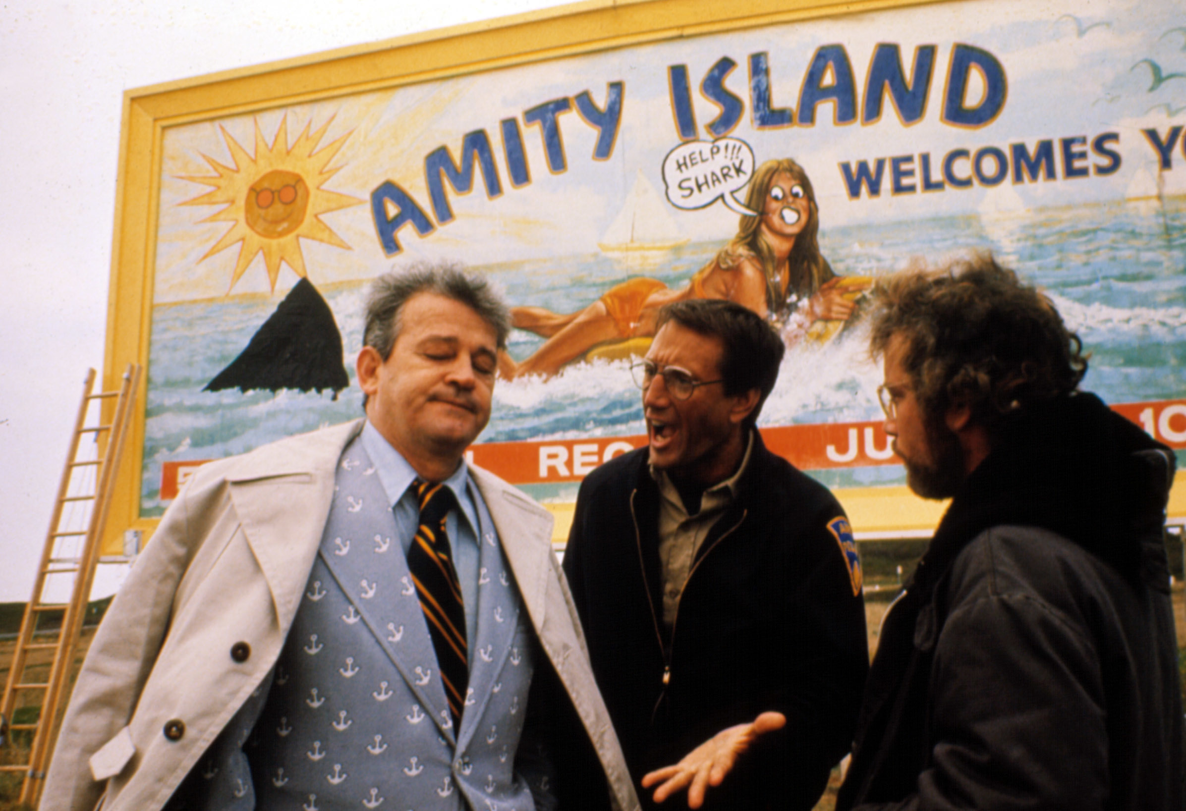 From left: Murray Hamilton, Roy Scheider, and Richard Dreyfuss stand in front of an &quot;Amity Island Welcomes You&quot; billboard in a scene from &quot;Jaws&quot;