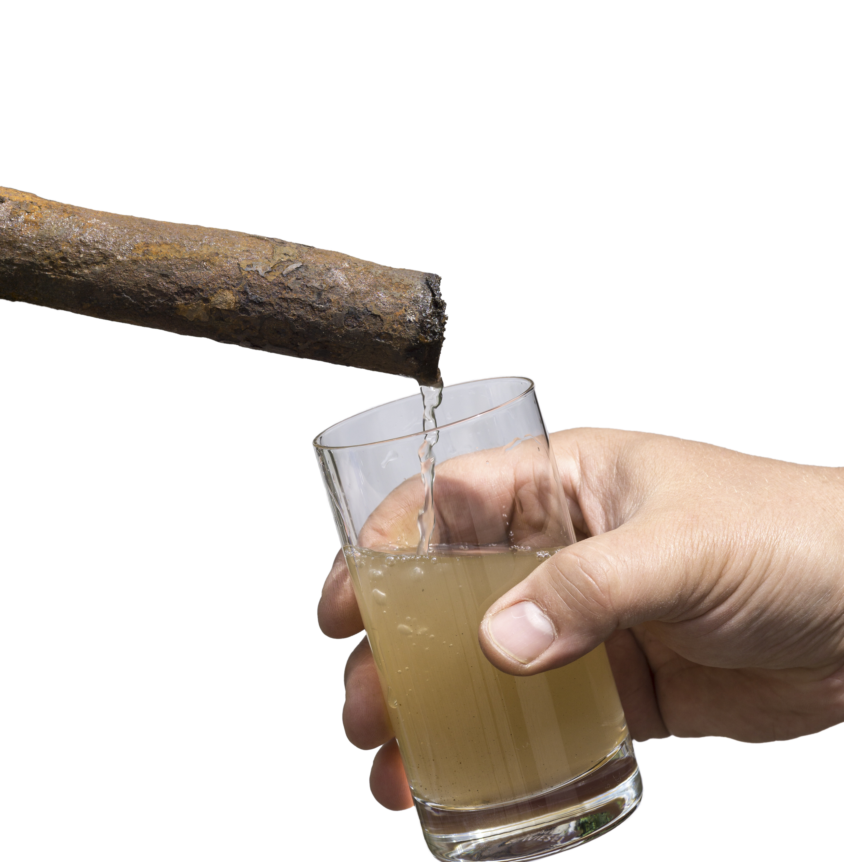 Rusty pipe pouring contaminated water into a glass held by a hand