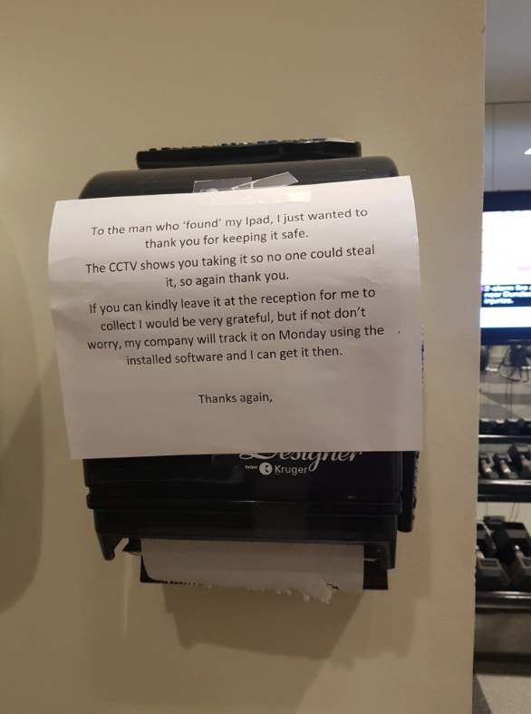 Note left on a paper towel dispenser thanking someone for finding an iPad and asking for it to be returned to reception. Mentions CCTV footage and recovery plan