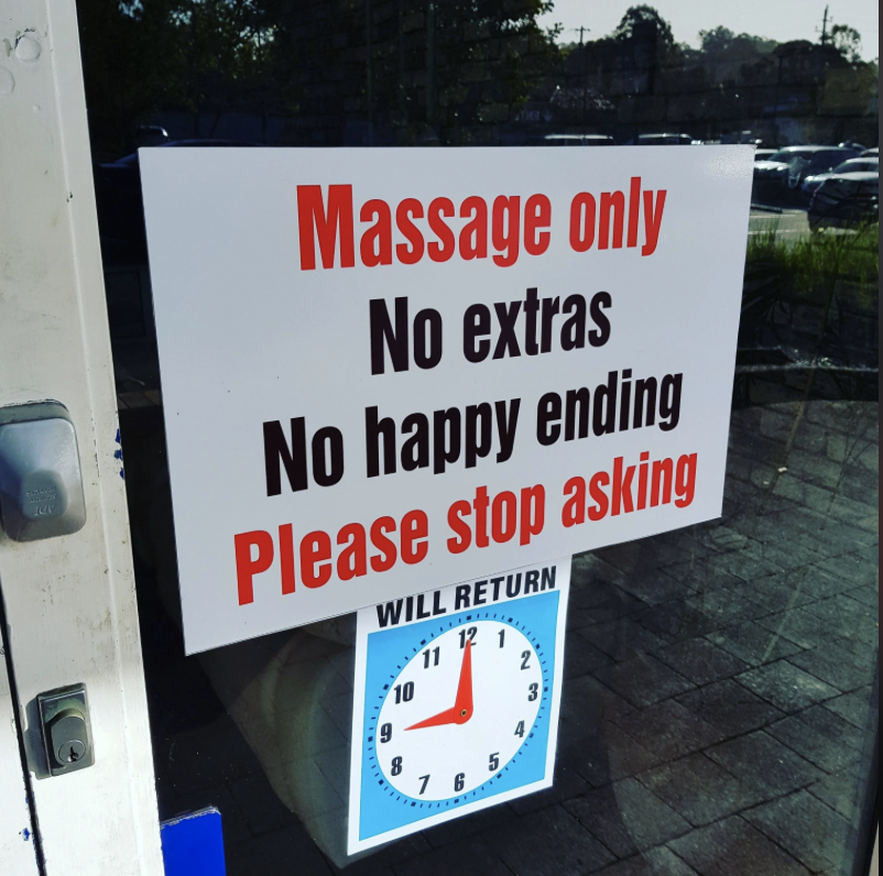 A sign on a door reads, &quot;Massage only, No extras, No happy ending, Please stop asking.&quot; There is also a clock sign below indicating the return time