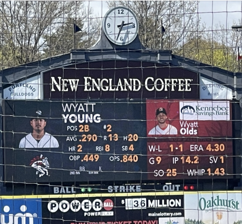 Scoreboard at a Portland Sea Dogs game showing stats for players Wyatt Young and Wyatt Olds, including batting averages, home runs, and pitching records