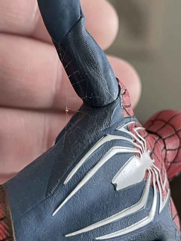 Close-up of a Spider-Man figurine showcasing intricate webbing details on its suit