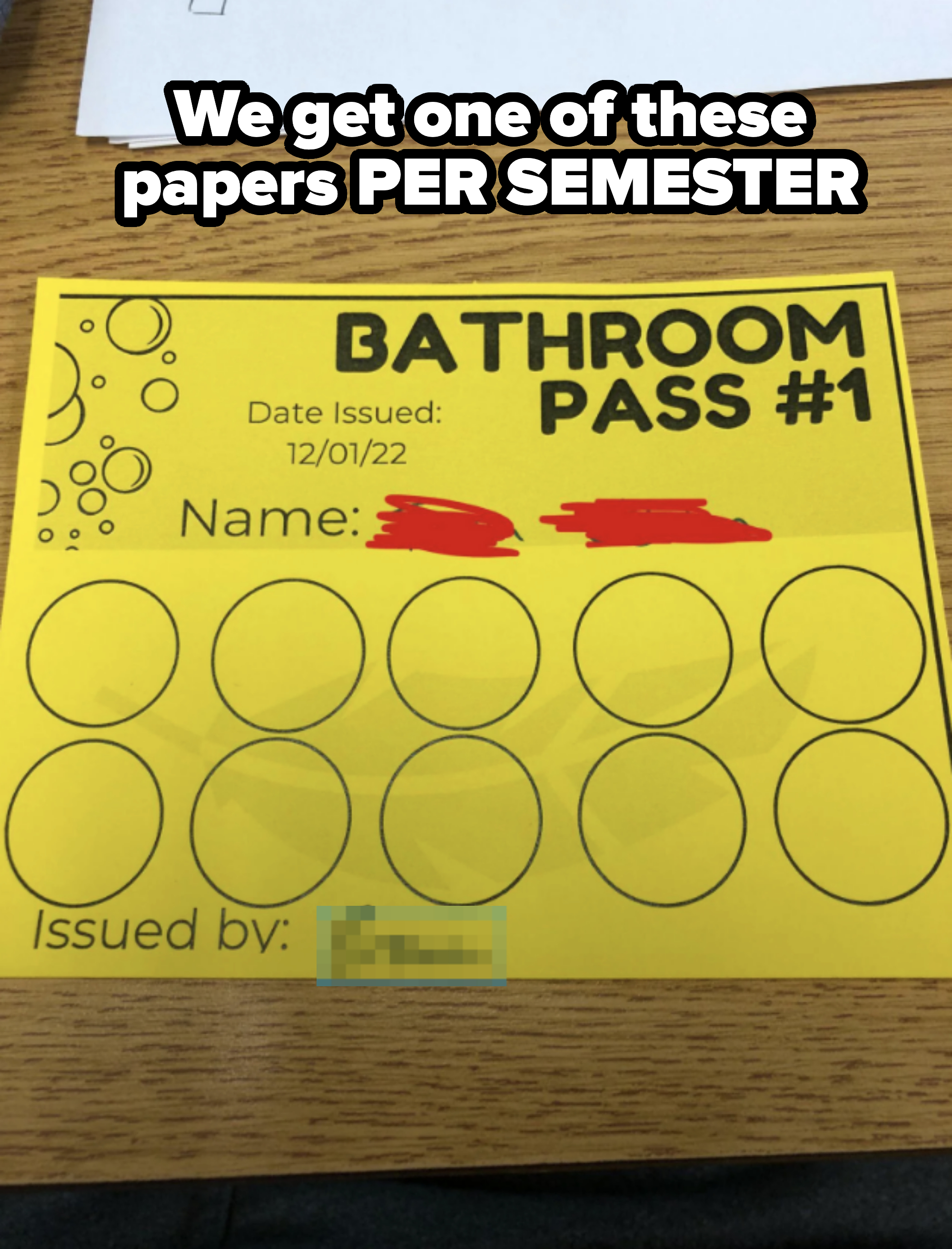 A yellow bathroom pass card titled &quot;Bathroom Pass #1&quot; with circles for markings. Issued on 12/01/22 by Brown