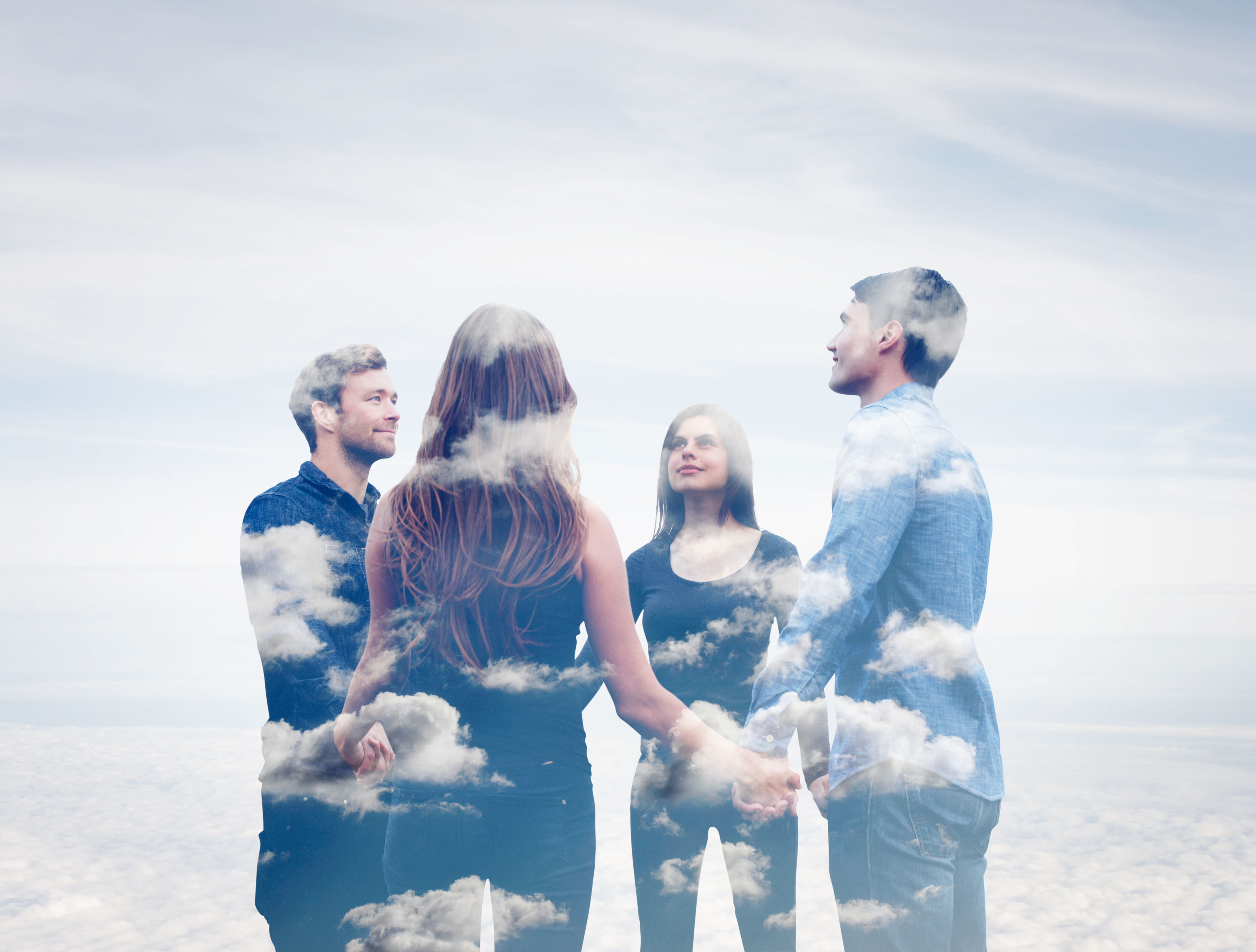 Four people stand in a circle holding hands, with a cloudy sky superimposed over them