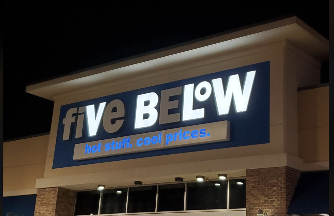 Storefront of Five Below with the slogan &quot;hot stuff. cool prices.&quot; displayed prominently above the entrance