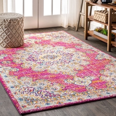 A brightly patterned area rug with intricate details graces a room with neutral decor, a woven basket, and a wooden shelf, as seen in a shopping feature