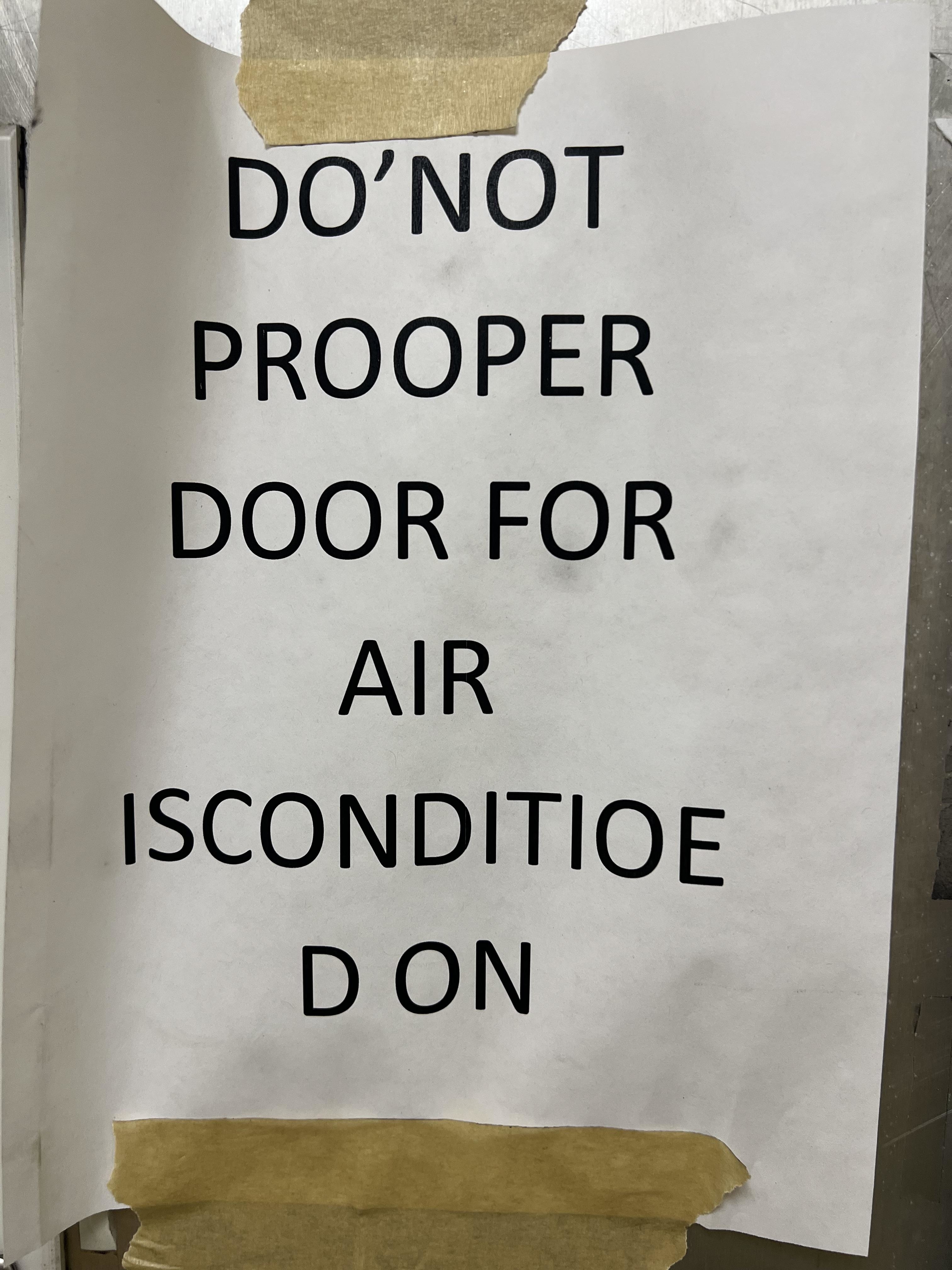 Sign reads: &quot;Do not prooper door for air isconditioe d on.&quot;