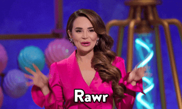 A woman in a pink outfit playfully makes a claw gesture with her hands, saying &quot;Rawr&quot; in animated text