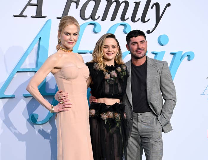 Nicole Kidman, Joey King, and Zac Efron pose together at the &quot;A Family Affair&quot; event. Nicole wears a chic beige dress, Joey dons a floral black outfit, and Zac sports a gray suit