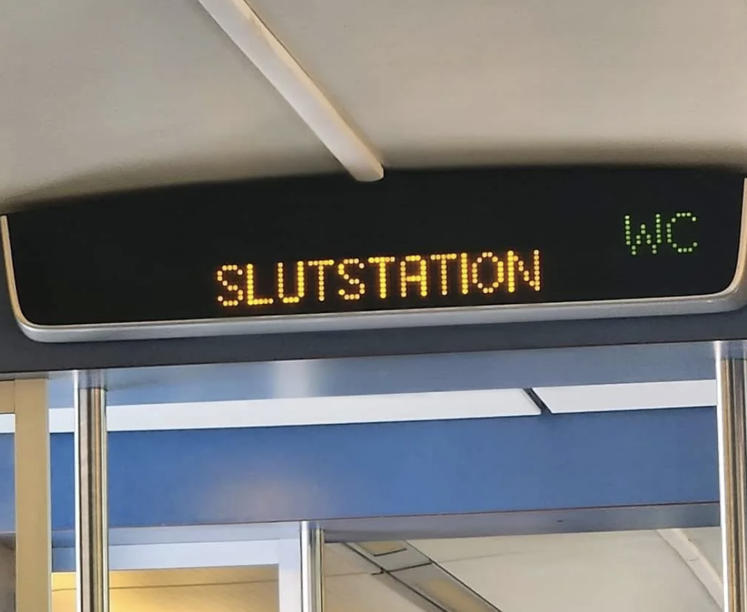 Train sign displaying &quot;SLUTSTATION&quot; and &quot;WC&quot; indicating the end of the line and restroom facilities