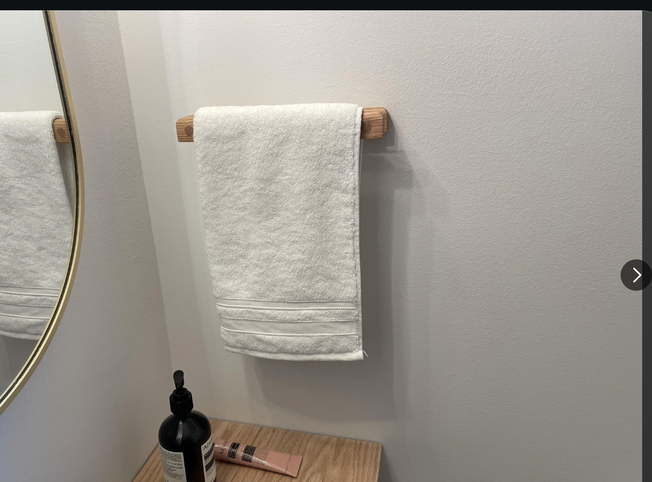 Screenshot of a Reddit post on r/woodworking showing a floating red oak vanity, a matching towel holder, and floating shelves after a bathroom remodel