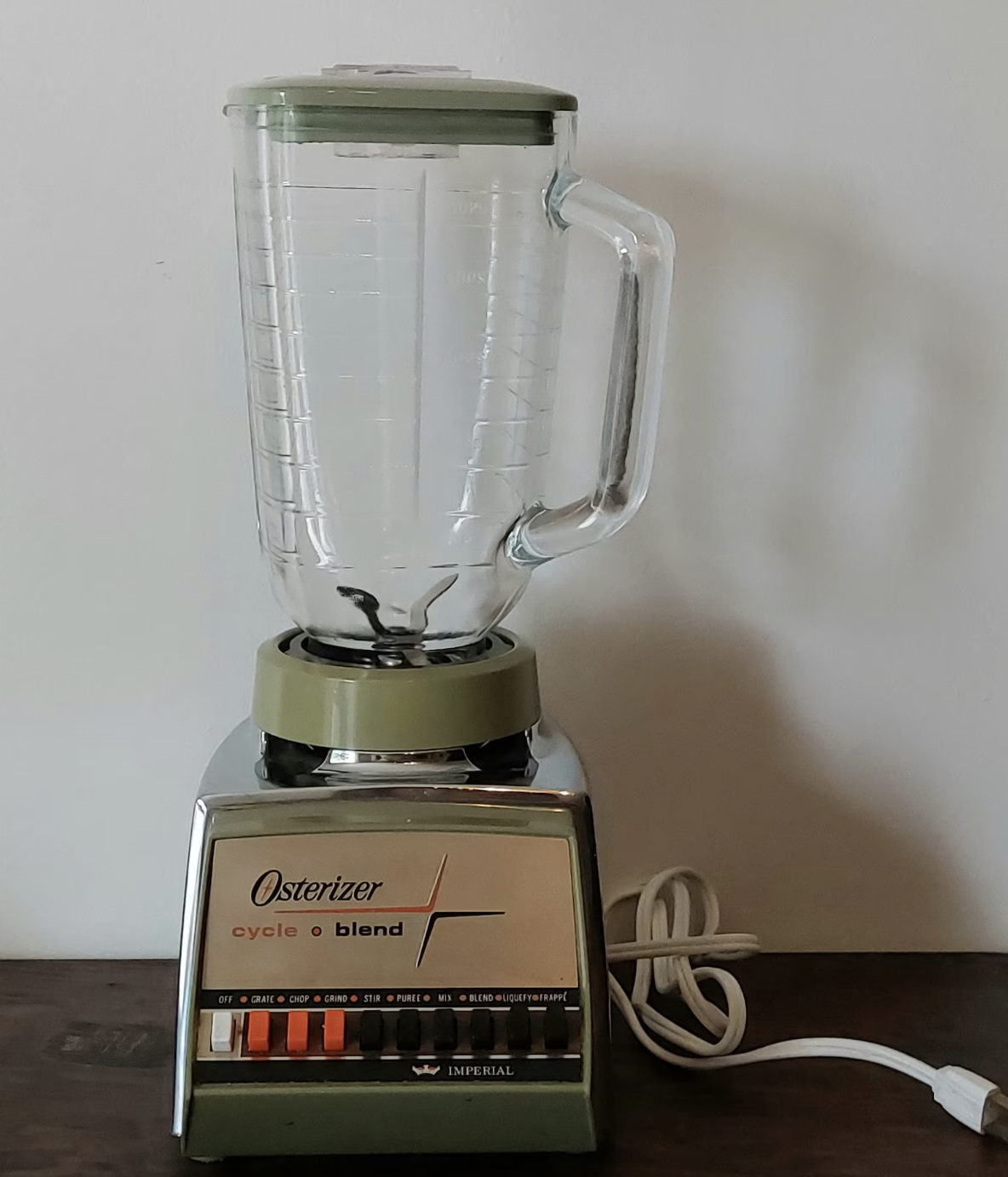 Osterizer Classic Vintage Blender with a glass jar and various speed settings. The brand name &quot;Osterizer&quot; and the model &quot;cycle blend&quot; are clearly visible