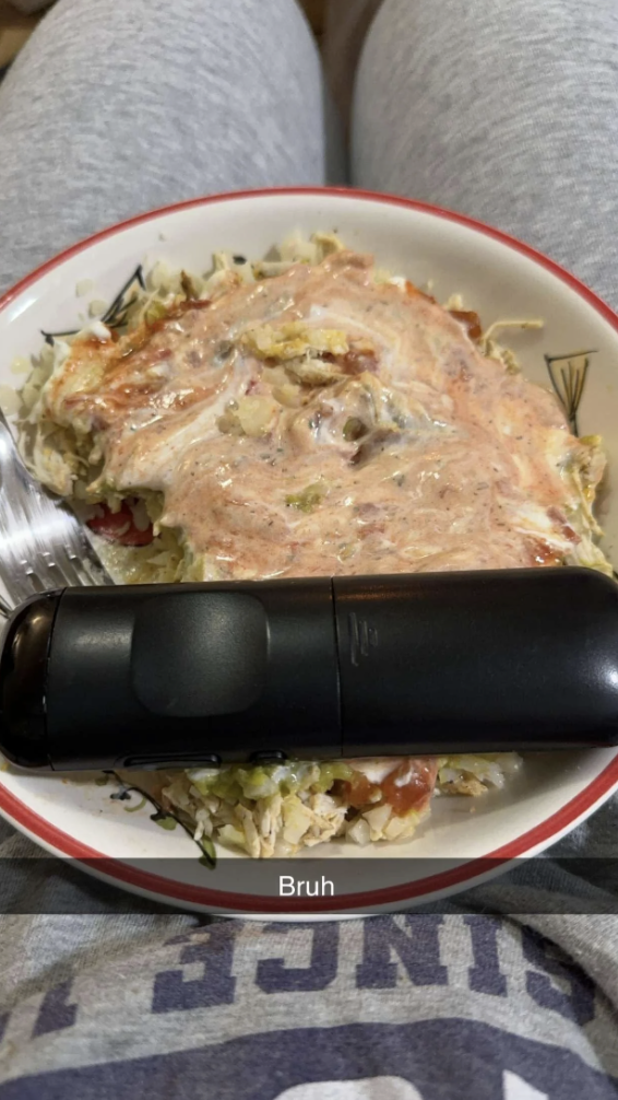 Remote control on a plate of shredded cabbage covered in sauce with a fork beside it; the caption reads, &quot;Bruh&quot;