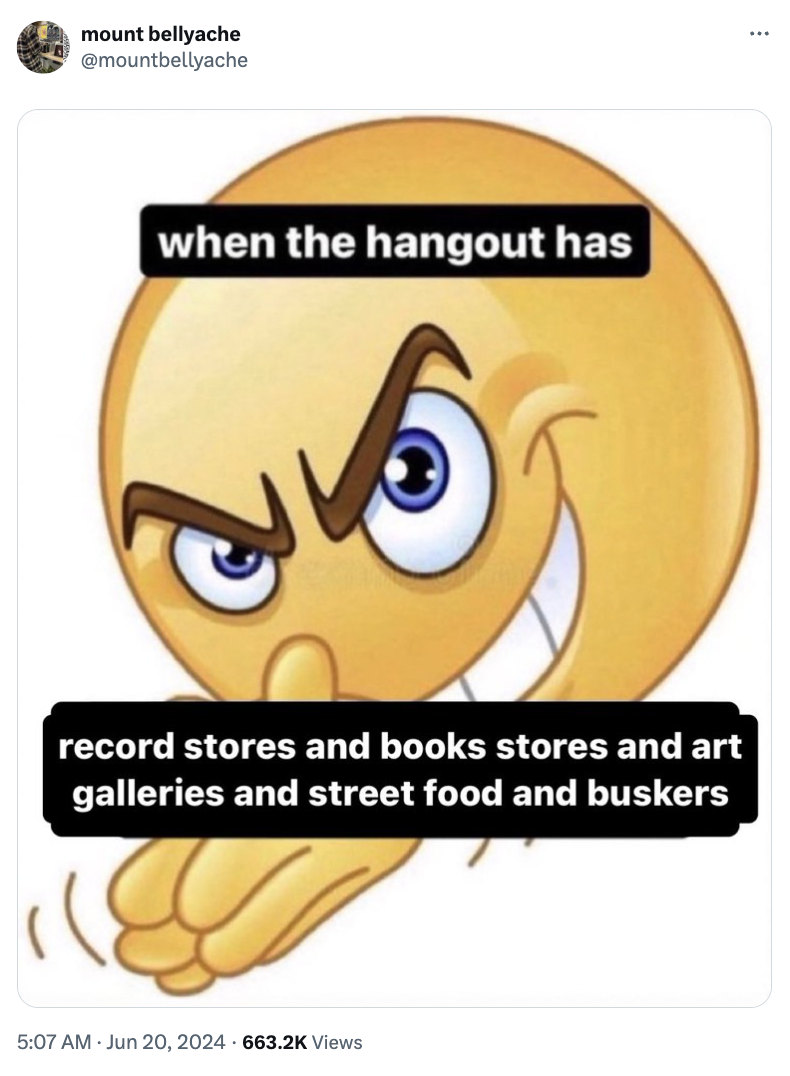An emoji with a conniving expression, captioned &quot;when the hangout has record stores and book stores and art galleries and street food and buskers.&quot;