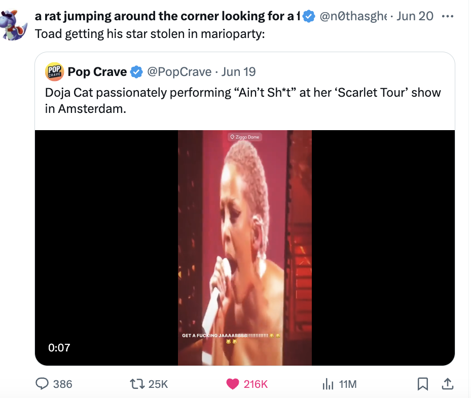 Tweet from @popcravenews with a video screenshot of Doja Cat performing &quot;Ain&#x27;t Sh*t&quot; at her &#x27;Scarlet Tour&#x27; show in Amsterdam