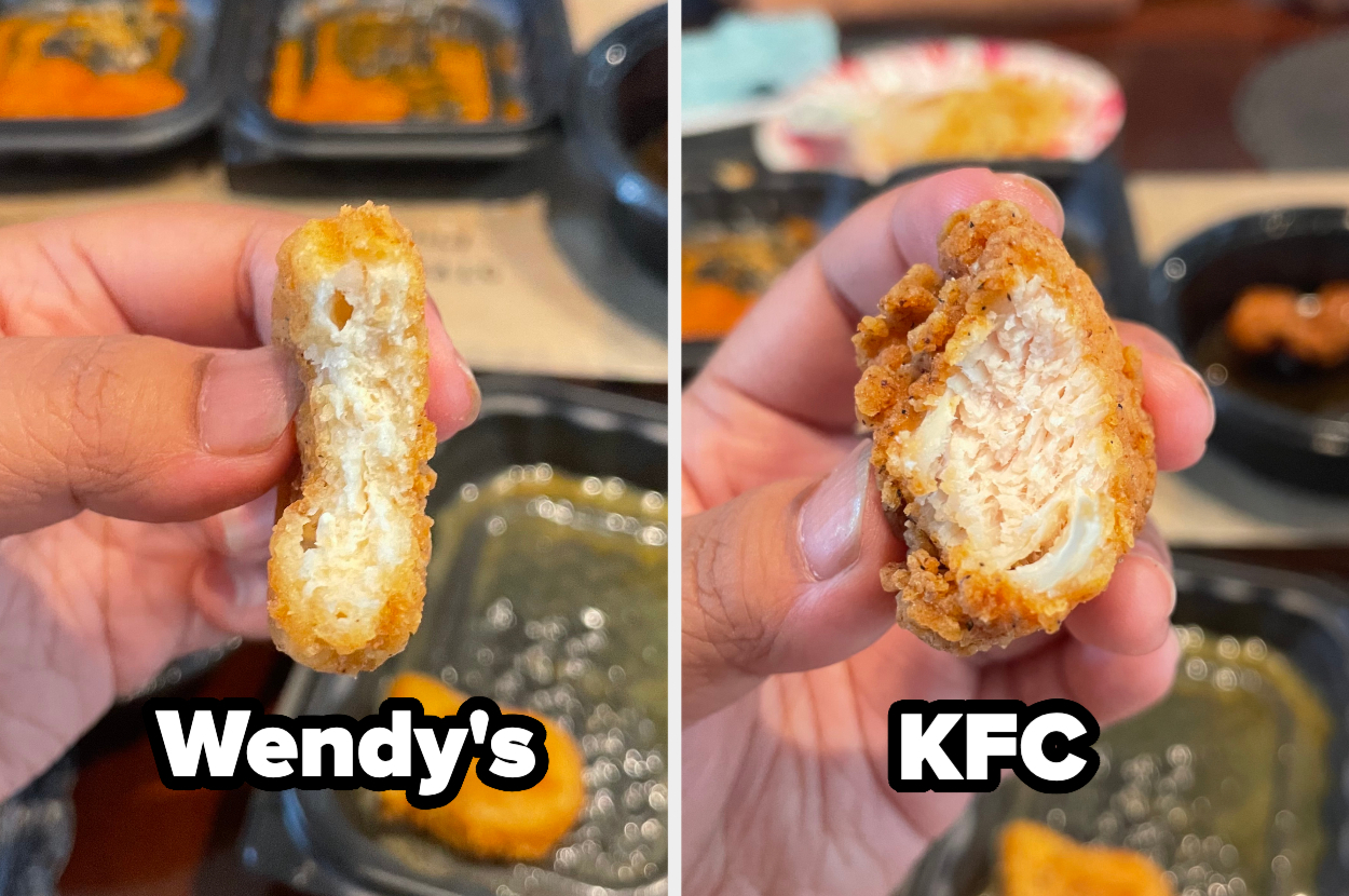 Close-up of a hand holding a Wendy&#x27;s chicken nugget next to another hand holding a KFC chicken nugget. The interiors of both nuggets are visible