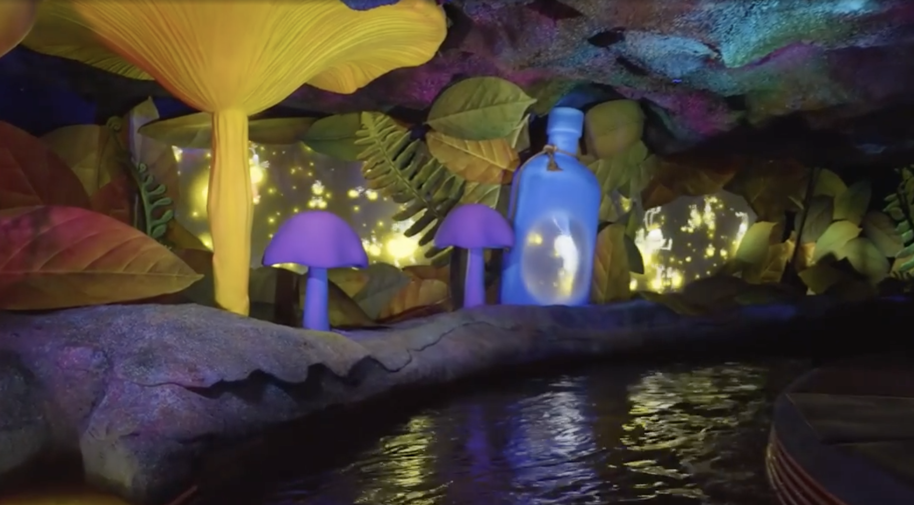 Animated scene of a fantastical cave with glowing mushrooms, leaves, and a large bottle emitting light. A serene water stream runs through the cave