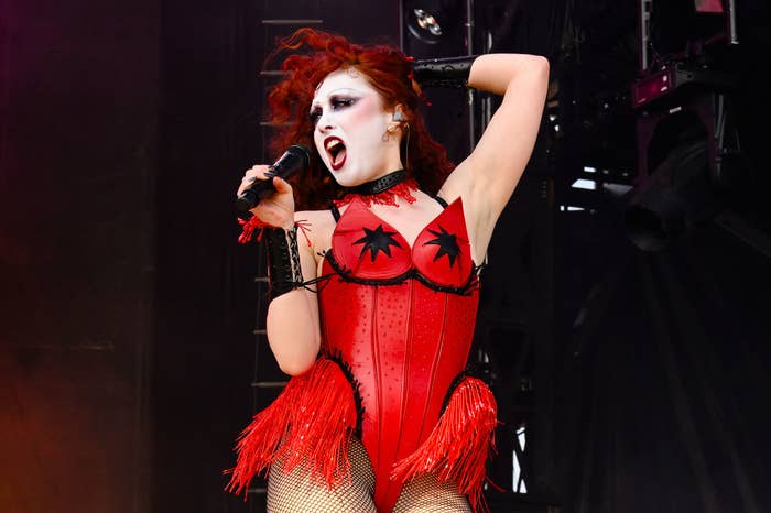 Chappell Roan in a corset-style top and fringed fishnet bottoms performs energetically on stage