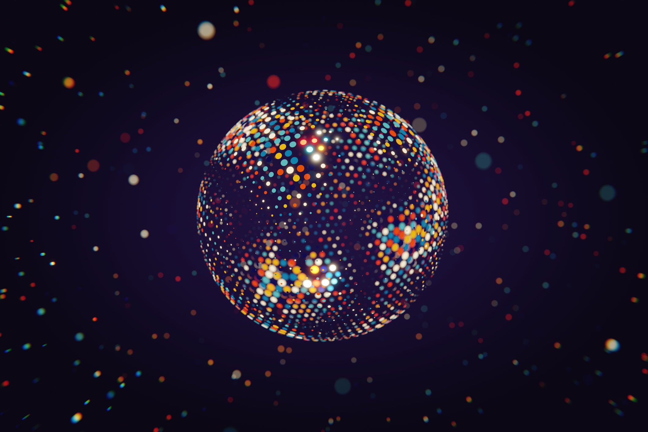 A spherical disco ball with various small, colorful reflective tiles, set against a dark background with scattered light reflections