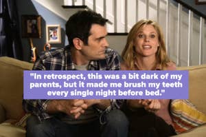 Phil Dunphy, in a plaid shirt, sits on a couch next to Claire Dunphy, in a casual blouse, both talking animatedly in a home setting from Modern Family