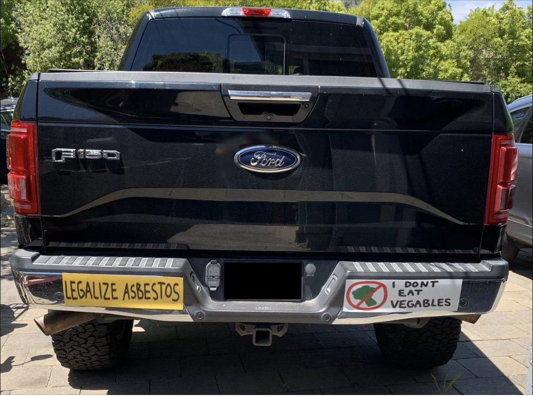Ford F-150 truck with bumper stickers: &quot;LEGALIZE ASBESTOS&quot; and &quot;DON&#x27;T EAT VEGABLES&quot; with a crossed-out vegetable graphic