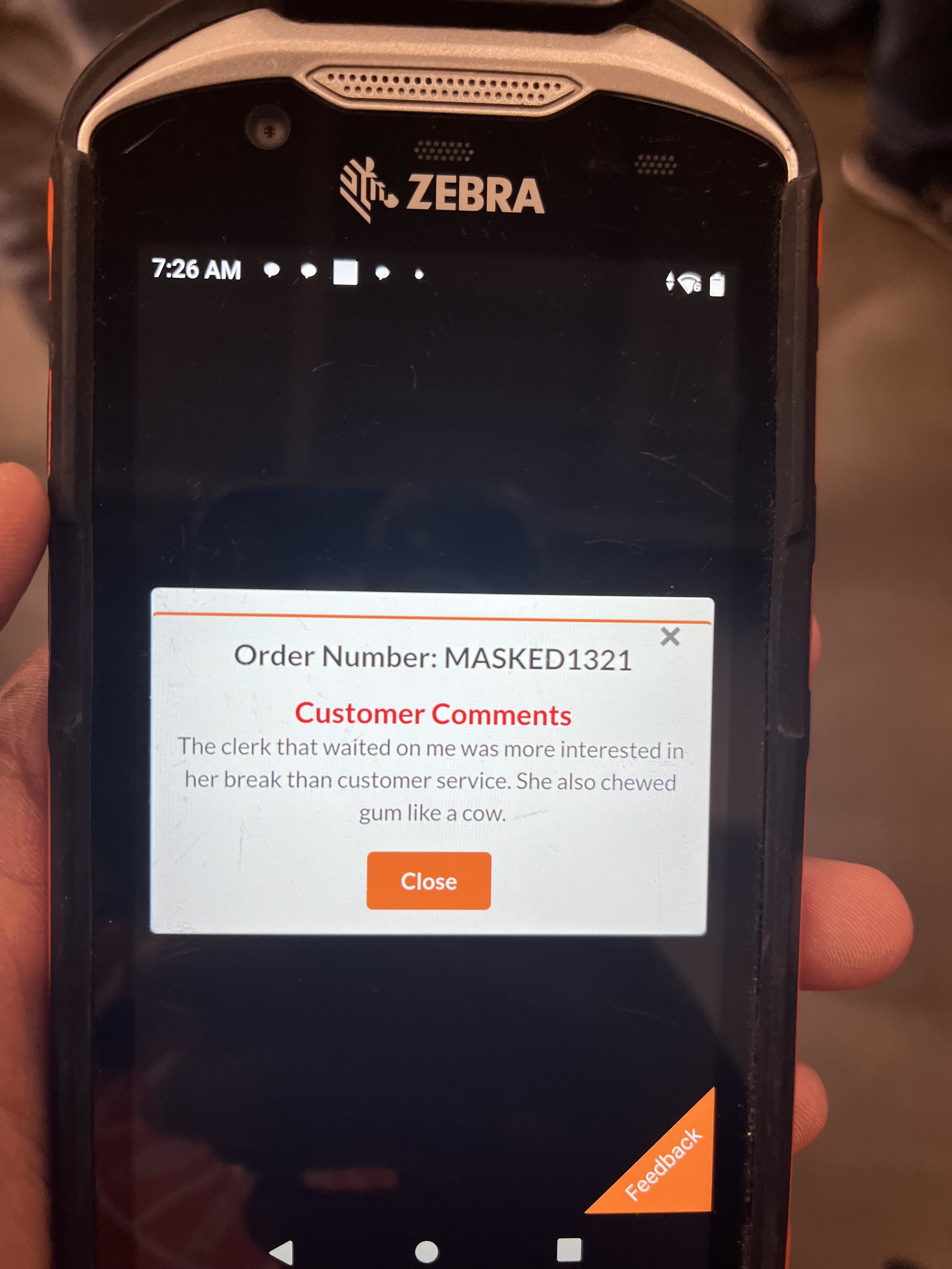 A handheld device displays customer comments. Text reads, &quot;The clerk that waited on me was more interested in her break than customer service. She also chewed gum like a cow.&quot;