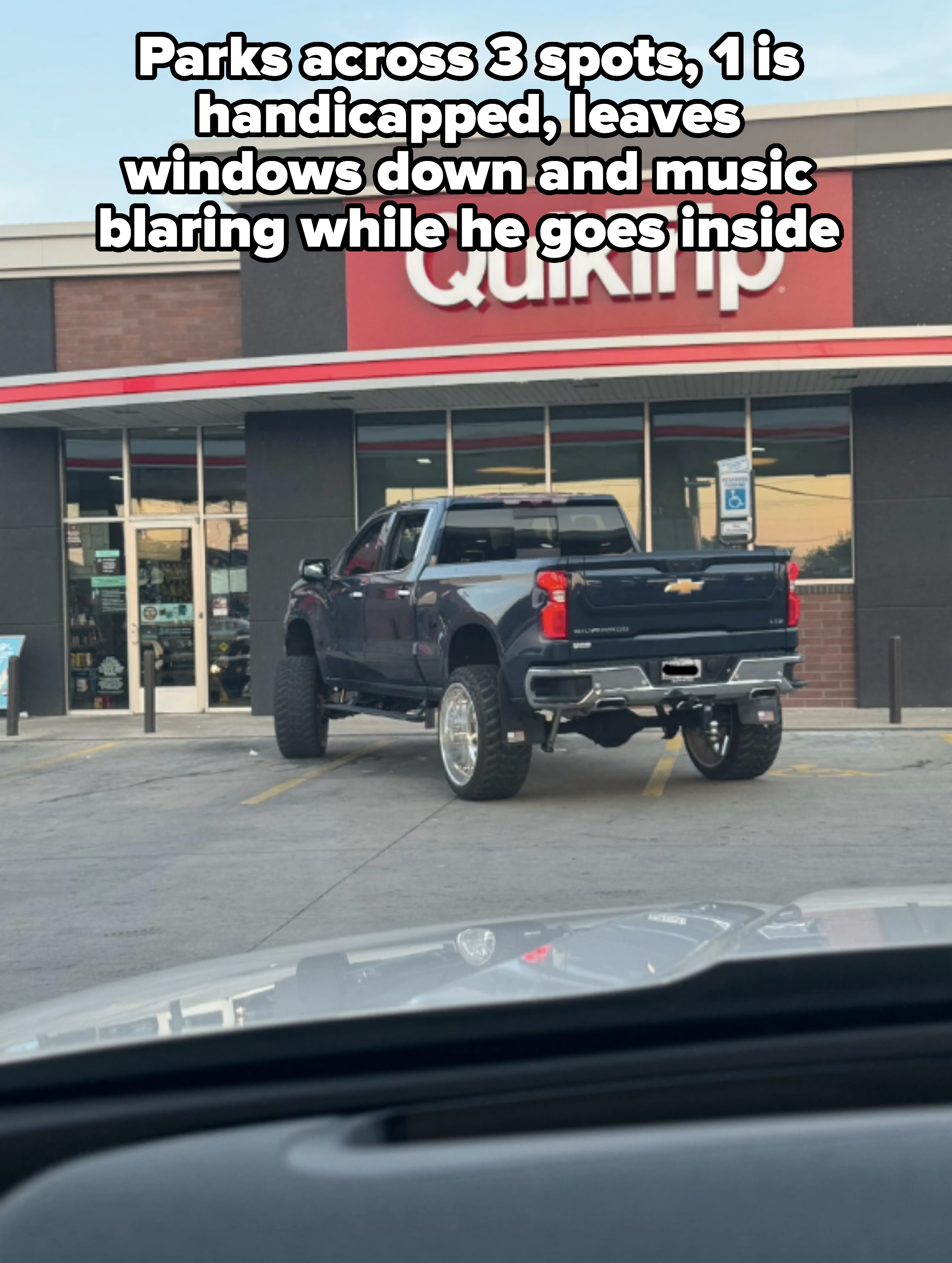 A large lifted Chevrolet truck is parked in front of a QuikTrip convenience store