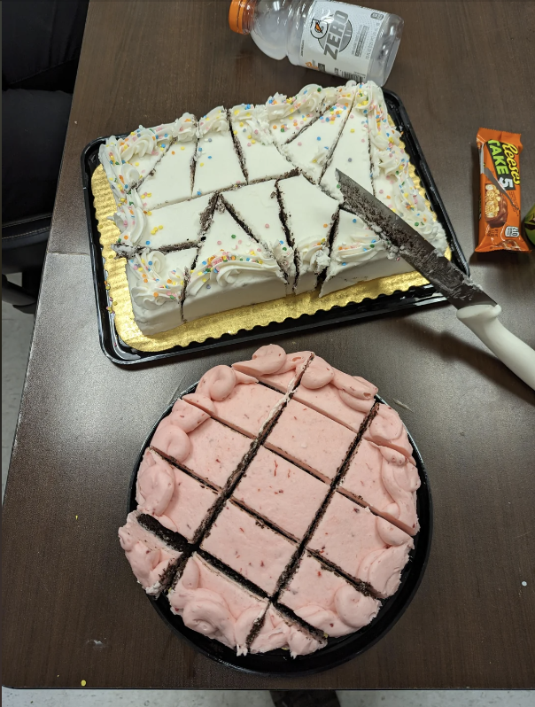 Two cakes, one with white icing and sprinkles and the other with pink icing, both pre-sliced into pieces. There is a Reese&#x27;s snack and a Gatorade bottle nearby