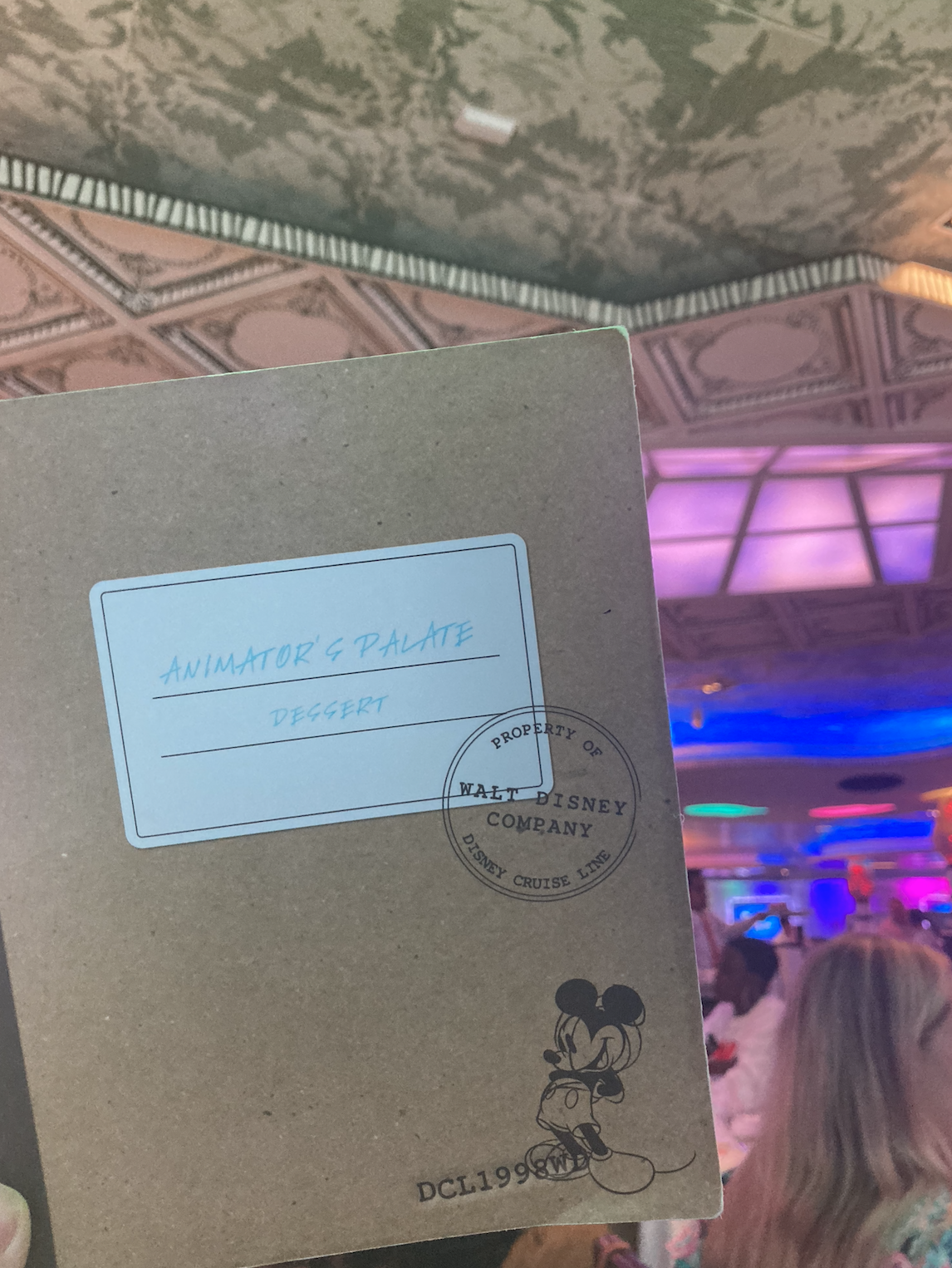 Menu for Animator&#x27;s Palate restaurant on Disney Cruise Line open to the dessert section showing the Disney trademark