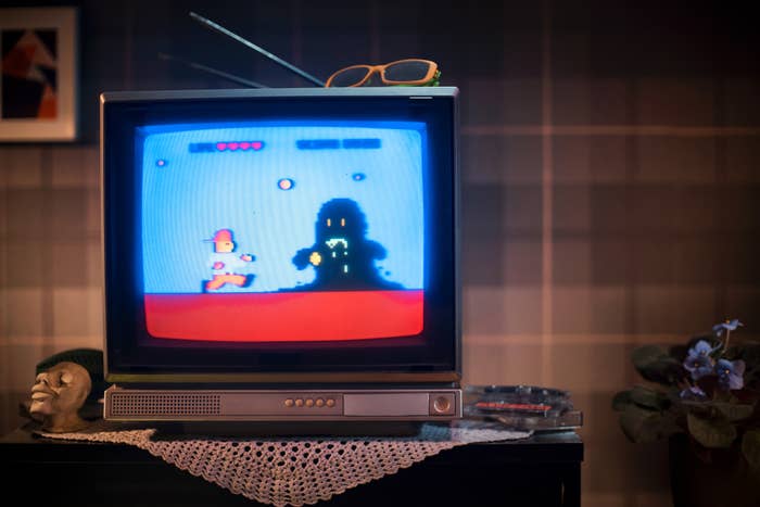 A retro television screen displaying a pixelated video game