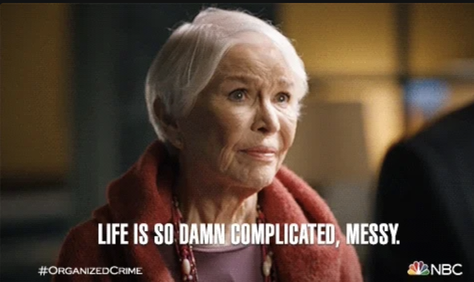 Older woman in a serious expression, wearing a red coat with jewelry, caption reads: &quot;Life is so damn complicated, messy.&quot; &quot;#ORGANIZEDCRIME #NBC&quot; logo shown