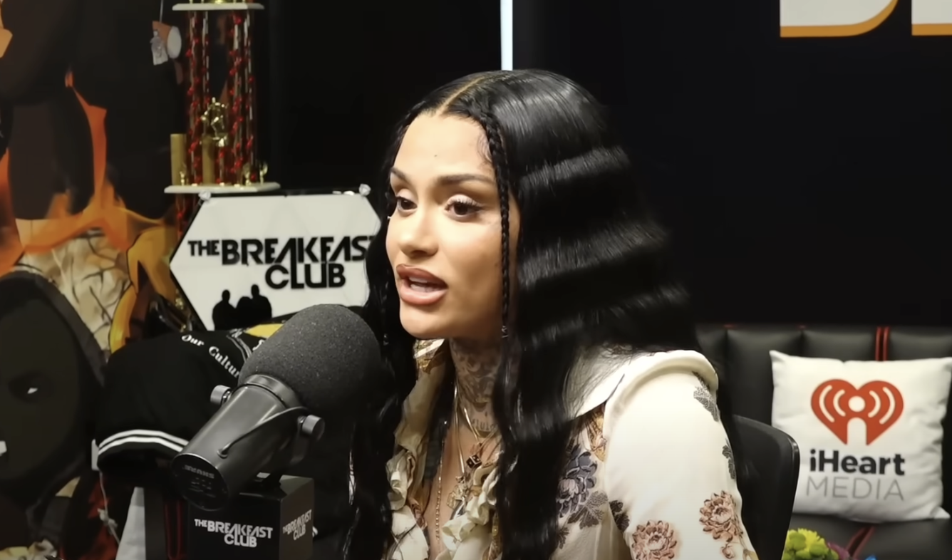 Kehlani speaking into a microphone during an interview at The Breakfast Club radio show