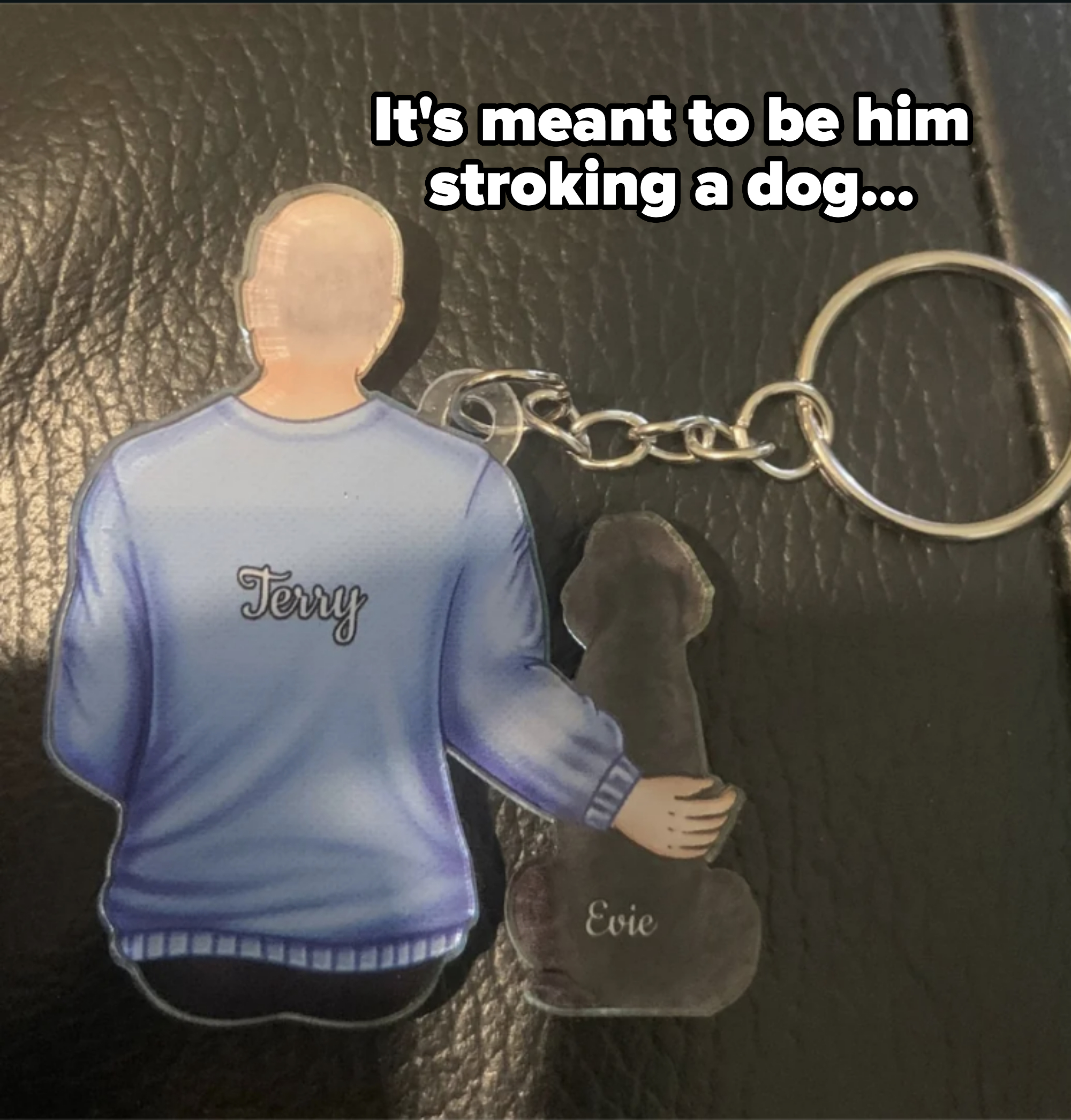 Cartoon figures of Terry and a dog named Evie are depicted on a keychain. Terry is shown from the back, hugging Evie