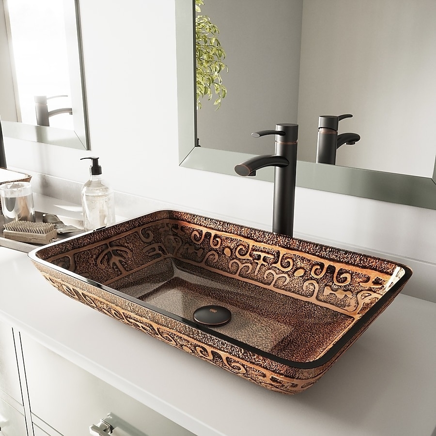 Intricately designed rectangular sink with decorative patterns, featuring a modern black faucet, set on a white bathroom countertop with a mirror and soap dispenser