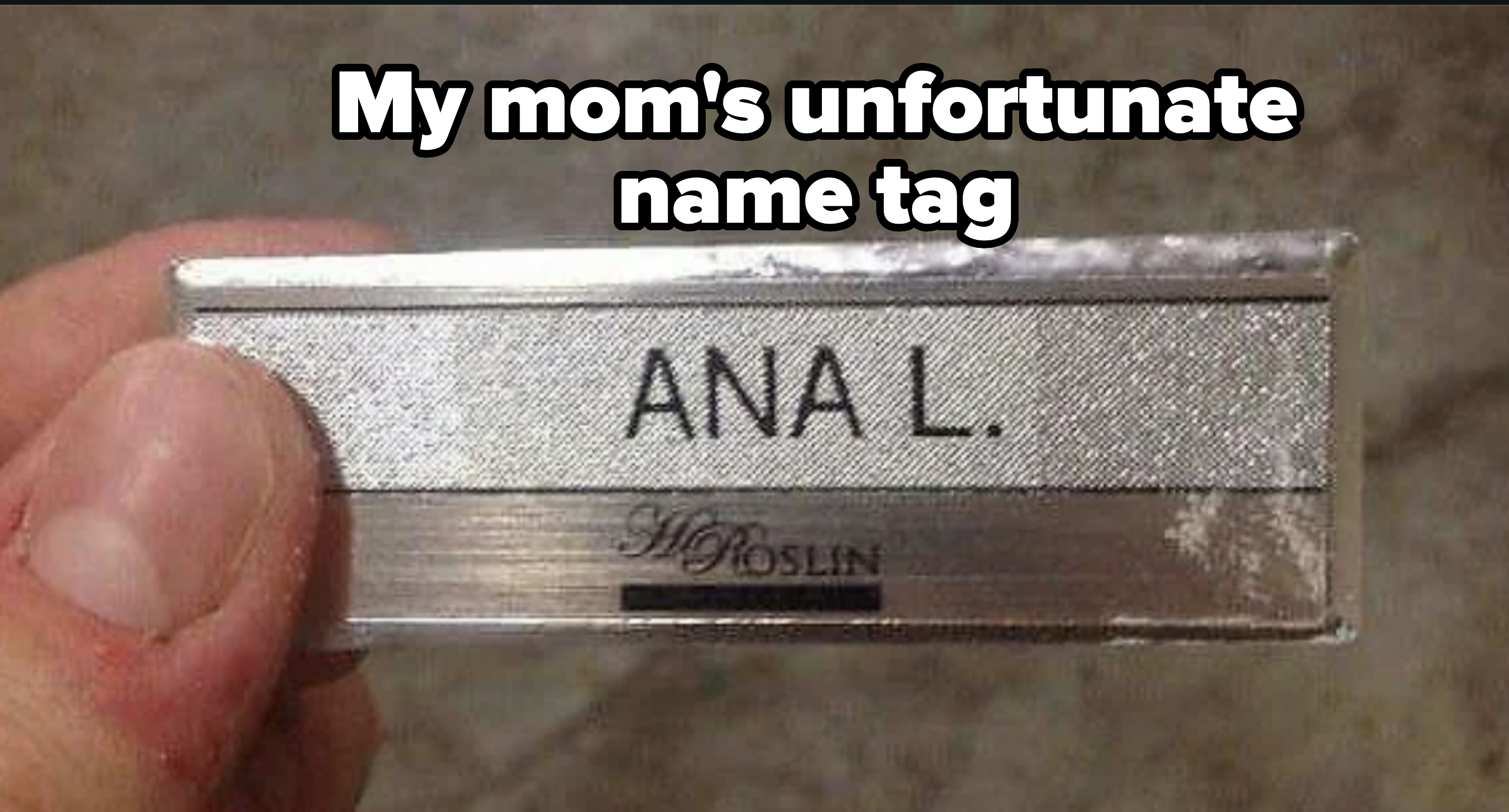 Name badge with the text &quot;ANA L.&quot; held up close, below a logo reads &quot;St. Roslin&quot;
