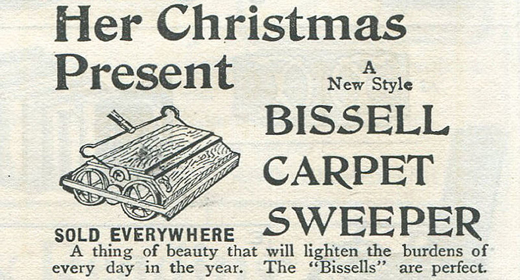 Vintage advertisement for a Bissell carpet sweeper, highlighting it as a perfect Christmas present that &quot;lightens the burdens of every day in the year.&quot;