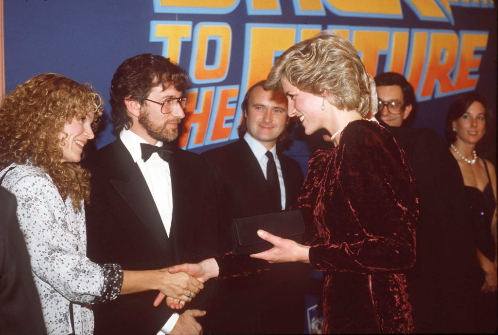 Sarah Jessica Parker shakes hands with Princess Diana at &quot;Back to the Future&quot; event, with Steven Spielberg, Phil Collins, and others in the background