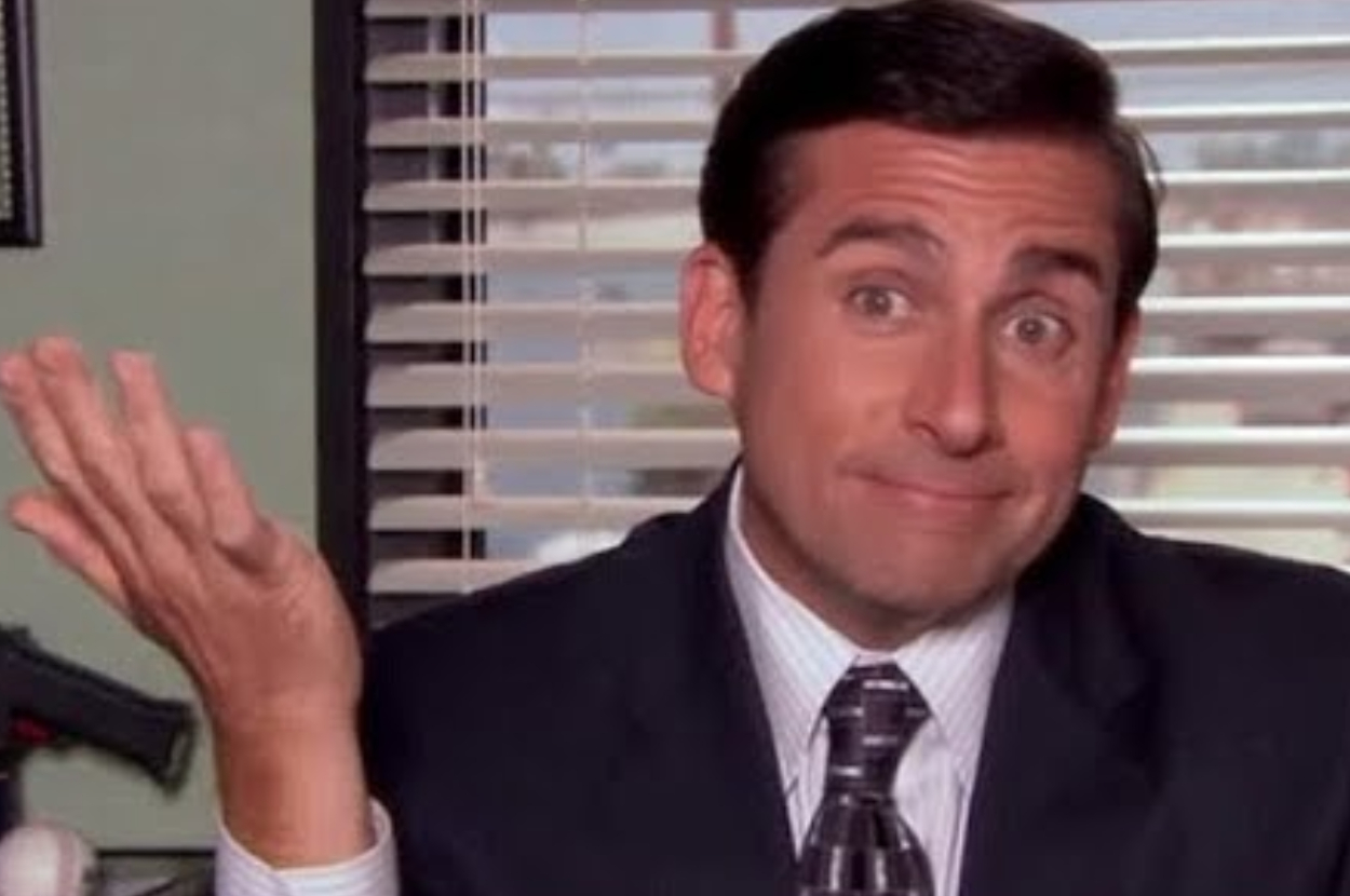 Steve Carell, in character as Michael Scott from The Office, shrugs with an amused expression, appearing to say, &quot;I don&#x27;t know,&quot; in an office setting