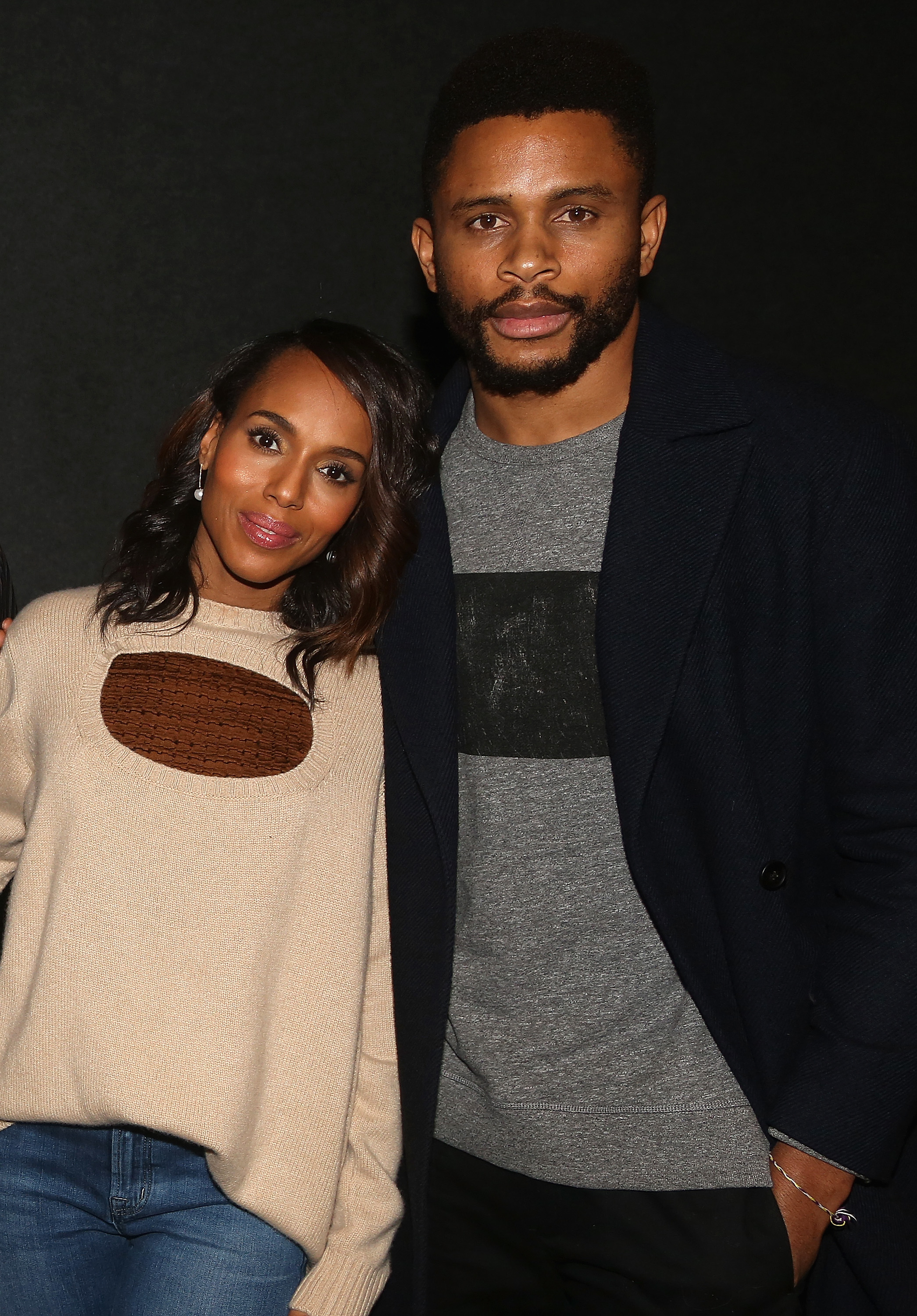 Kerry Washington, in casual sweater and jeans, posing with Nnamdi Asomugha, wearing a coat over a t-shirt