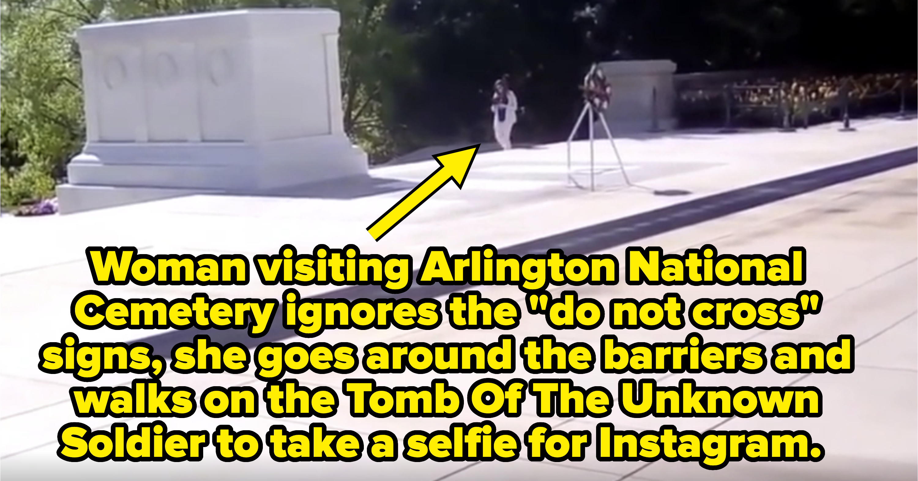 A guard stands at the Tomb of the Unknown Soldier with a wreath on a stand nearby. The tomb is a solemn white monument