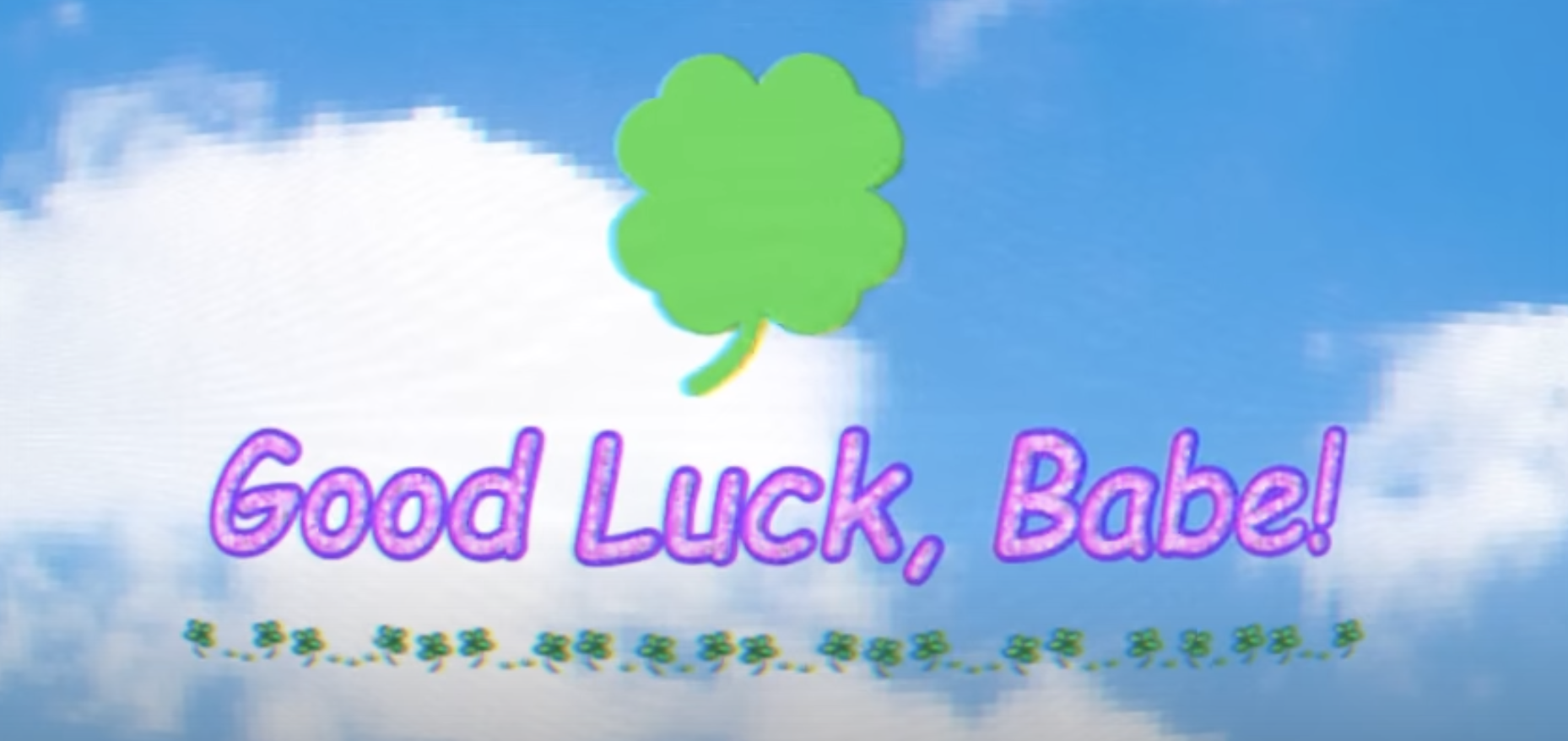 A green clover and purple text saying &quot;Good Luck, Babe!&quot; are set against a cloudy sky background