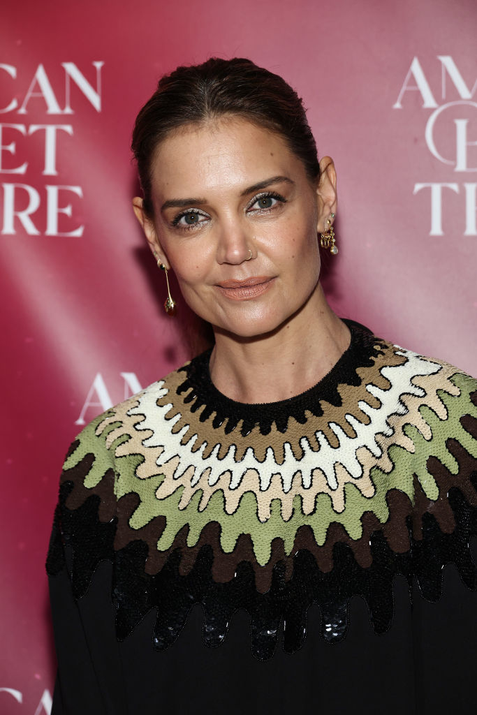 Katie Holmes at an American Ballet Theatre event in a black dress with intricate green and white textured detailing around the neckline